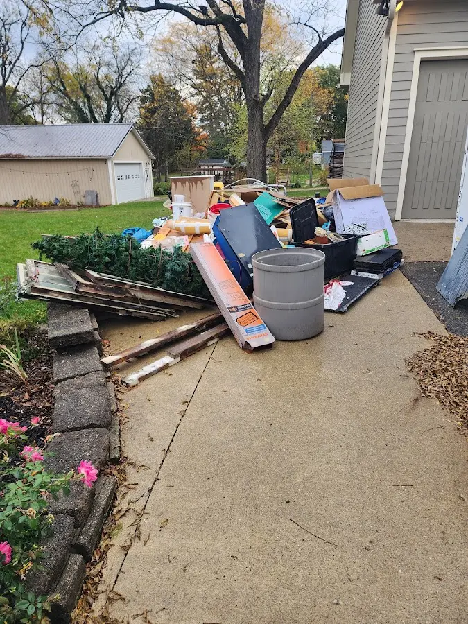 Dumpster being loaded with debris for Estate Cleanout Dumpster Rental in St. Clair Shores